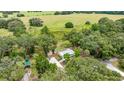 Aerial shot of the home on a spacious lot, featuring a long driveway and a separate structure at 22535 Sw 117Th St, Dunnellon, FL 34431