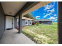 View of home entrance from covered porch with front yard views at 263 Chestnut Rd, Ocala, FL 34480