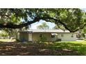 The backyard features mature trees providing shade and a secluded outdoor area at 2810 Se Lake Weir Ave, Ocala, FL 34471