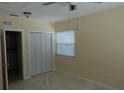 Bedroom with a window and closet, beige walls and tile floor at 2810 Se Lake Weir Ave, Ocala, FL 34471
