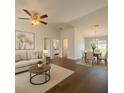 Inviting living room and dining area featuring neutral tones, hardwood floors, and plenty of natural light at 3527 Sw 149Th Ter, Ocala, FL 34481