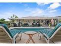 Inviting pool area with comfortable lounge chairs and a covered patio, ideal for relaxation and outdoor gatherings at 460 E Haines Blvd, Lake Alfred, FL 33850