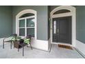Welcoming front entrance with stylish chairs, a decorative door, and tiled flooring at 488 Seth Run, The Villages, FL 32163