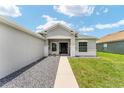Inviting home with fresh landscaping and a walkway to the front door at 5133 Sw 41St Pl, Ocala, FL 34474