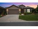 Charming single-story home featuring a well-maintained lawn, manicured shrubs, and a neutral-colored stucco facade at 6776 Sw 95Th Cir, Ocala, FL 34481