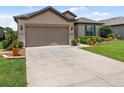 Beautiful home showcasing a spacious driveway, manicured lawn, and thoughtfully landscaped garden beds at 6776 Sw 95Th Cir, Ocala, FL 34481