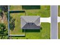 An aerial view of a well-maintained single-story home with fenced yard and lush green landscaping at 7133 Sw 135Th Pl, Ocala, FL 34473