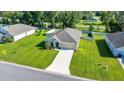 A single-story home with a well-manicured lawn and driveway situated amongst green lawns and neighborhood streets at 7133 Sw 135Th Pl, Ocala, FL 34473