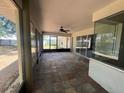 Spacious screened lanai with tile flooring and ceiling fan, perfect for outdoor living and entertaining at 8100 Sw 56Th Ter, Ocala, FL 34476