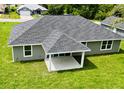 Aerial view of a single-story home highlighting the backyard patio and green lawn at 8289 Se 159Th Ln, Summerfield, FL 34491
