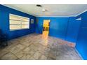 Cozy living room with blue walls and windows bringing in lots of natural light at 1051 Se 28Th Rd, Ocala, FL 34471