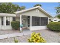 Inviting front porch with screened-in area, decorative plants, and a welcoming entrance at 10806 Sw 86Th Ave, Ocala, FL 34481