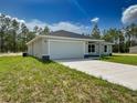 Stylish one-story home showcasing a two-car garage, neutral paint, and a concrete driveway at 1390 Sw Obee Ridge Rd, Dunnellon, FL 34431