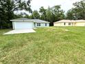 Lovely single-story home with an attached two-car garage and a spacious green lawn at 13921 Sw 108Th Ln, Dunnellon, FL 34432
