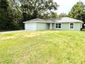 Inviting single-story home featuring a well-manicured lawn and an attached two-car garage at 13921 Sw 108Th Ln, Dunnellon, FL 34432
