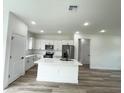 Modern kitchen featuring a central island, stainless steel appliances, and ample counter space at 142 Guava Pass, Ocklawaha, FL 32179