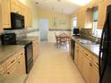 A well-lit kitchen features updated appliances and plenty of cabinet space at 14695 Sw 112Th Cir, Dunnellon, FL 34432