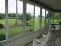 A beautiful outdoor view from a screened lanai provides the perfect spot for relaxation at 14695 Sw 112Th Cir, Dunnellon, FL 34432