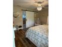 Cozy bedroom featuring a barn door entrance to the ensuite bathroom, complemented by stylish decor at 16023 Sw 14Th Avenue Rd, Ocala, FL 34473