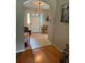 Inviting foyer with tile flooring and view of the front door, enhanced by a decorative chandelier at 16023 Sw 14Th Avenue Rd, Ocala, FL 34473