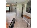 Open hallway view with tile flooring, arched doorways, and a wooden console table enhancing the interior's charm at 16023 Sw 14Th Avenue Rd, Ocala, FL 34473