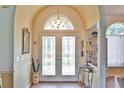 Grand entryway showcasing beautiful double doors, transom window and arched ceiling for an inviting welcome at 2478 Nw 50Th Ave, Ocala, FL 34482