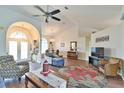 Inviting living room boasts vaulted ceilings, wood-look tile flooring, and a seamless flow into other living spaces at 2478 Nw 50Th Ave, Ocala, FL 34482