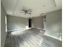 Open-concept living room with hardwood floors, recessed lighting, and a modern tray ceiling at 3696 Se 139Th Ln, Summerfield, FL 34491