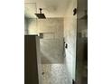 Modern bathroom featuring a sleek glass-enclosed shower with a rainfall showerhead and elegant tile work at 3696 Se 139Th Ln, Summerfield, FL 34491