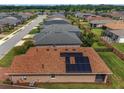 Aerial view of the home's solar panels situated on top of the brown-tiled roof at 5587 Nw 40Th Pl, Ocala, FL 34482