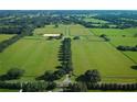 A large farm estate with fenced pastures and tree lined drive at 5765 Nw 110Th St, Ocala, FL 34482