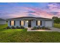 Charming single-story home exterior shows dusk sky and well-kept lawn at 6 Locust Loop Crse, Ocala, FL 34472