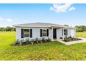 Attractive single-story home boasts a tidy lawn and inviting front entrance at 6 Locust Loop Crse, Ocala, FL 34472