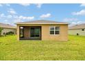 The backyard offers a screened patio with a spacious, well-maintained lawn at 6318 Sw 89Th Lane Rd, Ocala, FL 34476