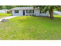Charming home with a well-manicured lawn, inviting entrance and blooming window box at 6511 Se 25Th Ave, Ocala, FL 34480