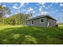 The spacious backyard features lush green grass perfect for outdoor activities and relaxation at 75 Guava Ter, Ocklawaha, FL 32179