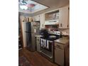 Compact kitchen with stainless steel appliances and ample cabinet space at 8343 Sw 105Th Pl, Ocala, FL 34481