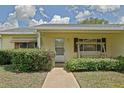 Inviting front porch with a sidewalk and a bench at 10699 Se 178Th St, Summerfield, FL 34491
