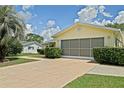 Attached garage with a screened-in door at 10699 Se 178Th St, Summerfield, FL 34491