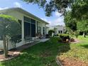 Spacious backyard featuring a covered patio, seating area, and lush landscaping at 11605 Sw 69Th Cir, Ocala, FL 34476