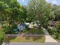Overhead view of a charming home with lush greenery and mature trees at 12335 Se 130Th Ct, Ocklawaha, FL 32179