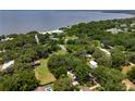 High aerial view of a waterfront community with houses and mature trees at 12335 Se 130Th Ct, Ocklawaha, FL 32179