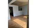 Bright living space featuring wood-look tile flooring and an open wall, with a view into adjacent room at 13155 Sw 73 Ave, Ocala, FL 34473