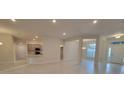 Open-concept living room with modern lighting, tile flooring and an eat-in kitchen at 13977 Sw 81St St, Dunnellon, FL 34432