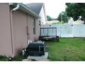 Side yard with equipment and a trailer, all next to a tall privacy fence at 14126 Greater Pines Blvd, Clermont, FL 34711