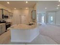 Modern kitchen featuring gray cabinets, stainless steel appliances, and a granite countertop island at 15055 Sw 25Th Cir, Ocala, FL 34473