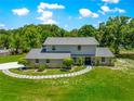 Beautiful two-story home with manicured lawn, decorative stone accents, and a welcoming walkway at 15621 Se 103Rd Ter, Summerfield, FL 34491