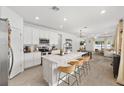 Bright, modern kitchen features a large island with seating, stainless steel appliances, and an open floor plan at 1814 Nw 44 Court Rd, Ocala, FL 34482