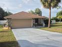 Charming home featuring a stone facade, a spacious driveway, and a well-maintained yard at 21511 Sw Plantation Sw St, Dunnellon, FL 34431