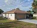 Charming home featuring a stone facade, a spacious driveway, and a well-maintained yard at 21511 Sw Plantation Sw St, Dunnellon, FL 34431